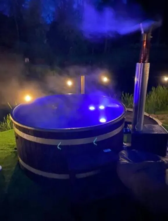 Illuminated wood-fired hot tub at Welham Lake